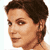 Pixelated static image of a person's head and shoulders with short dark hair, light skin tone, visible facial features including eyes, nose, mouth, and ear, against a plain white background.