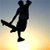 Silhouette of a person performing a skateboarding trick against a gradient sky background in a 50x50 pixel icon.