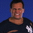 Static 48x48 pixel buddy icon showing a smiling man with short dark hair wearing a black shirt against a solid blue background, rendered in low-resolution pixel art style with visible dithering and color blending.