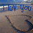Blue text reading 'I love you' overlaid on a pixelated beach scene with a curved shoreline and water.
