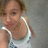 Pixelated image of a person with light brown hair wearing a white tank top with blue patterns, set against a muted gray background.