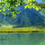Pixelated landscape with green foliage, blue water, and yellow ground, rendered in low-resolution mosaic style.