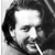 Black-and-white pixelated portrait of a man with dark hair and facial stubble, rendered in low-resolution grayscale with visible dithering and anti-aliased edges on the face.