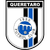 A shield-shaped icon with vertical black and blue stripes on a white background, featuring a central blue circular emblem with gray accents.