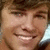 A person with brown hair and light skin smiles broadly, showing teeth in a close-up portrait across four