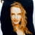 Pixelated portrait of a person with light brown hair against a dark background, showing a neutral expression and partial shoulder view.