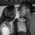 Two figures in a close embrace, one figure's head tilted toward the other's face in a kissing pose, visible in grayscale animation frames.