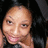 Pixelated close-up of a person with light skin tone, dark hair, and visible facial features including eyes, nose, mouth, and hand near the face against black background.