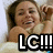 Pixelated image of a person with light brown hair holding a small animal, overlaid with large black-and-white text reading "LG!!!".