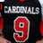 Black sports jersey with red number 9 and white 'CARDINALS' text, overlaid with multiple red and purple text elements.