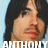 A pixelated image of a person with long dark hair against a light blue background, featuring text overlays and a small white symbol.