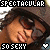 A pixelated image of a person wearing sunglasses and a brown hat, with text overlays reading "SPECTACULAR" in white and red, "SO SEXY" in black and red, and heart symbols changing from white to red.