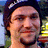 A pixelated image shows a person with dark hair and light skin on the left, next to blue text reading "BAM is SEXII" on a black background.