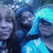 A group of people in blue hooded garments with a blurred background, displayed as four repeated