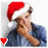 A pixelated figure wearing a red Santa hat and blue jacket, holding up one finger with a small red heart in the corner.