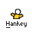 Pixelated character in yellow shirt and white head with brown limbs, some frames show red Santa hat on the character.