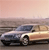 A pixelated static image shows a silver sedan with a dark roof driving on a road near a body of water under a pinkish sky.