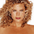 Pixelated close-up of a person with curly brown hair, closed eyes, and red lips against a white background.