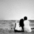 Black-and-white animated sequence showing a couple on a beach, transitioning from embracing to holding hands with an ampersand symbol.