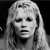 Pixelated grayscale image of a person with long straight hair, closed eyes, and a neutral expression against a dark background.
