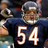 Pixelated image of a person in dark blue sports uniform with white number 54, wearing silver helmet and holding football.