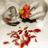 A pixelated image shows hands holding a red flower with a yellow center, red scattered petals, and text in Hindi and English.