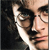Two overlapping human faces with dark hair and glasses, one face partially obscured by the other against a dark background.