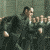 pixelated frames showing a group of people in formal attire seated at tables, with some individuals clapping or gesturing
