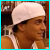 A split-frame contact sheet showing a pixelated image of a person with a white headband on the left and text with a cyan heart symbol on the right, both within a blue border.