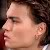 Pixelated close-up of a person's face in profile view with dark hair and light skin tone.