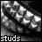 Two side-by-side pixelated grayscale images of a hand with fingers curled, each displaying the word 'studs' at the bottom in distinct fonts.