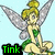 Pixelated fairy character with blonde hair in a bun, green dress, and silver wings sitting against light blue background.