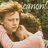A static image shows two people embracing outdoors with a blurred green background and the word 'canon!' in white text.