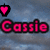 Pixelated pink text 'Cassie' with black outline over blue cloudy background, surrounded by pink heart icons in four corners.