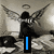 A black-and-white animated scene shows a winged figure with an angel halo standing in front of large speakers, while text changes sequentially across the frame.