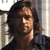 Pixelated close-up of a person with long dark hair wearing a dark top against a light background with vertical elements.
