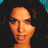 A 48x48 pixel animated contact sheet showing three sequential frames of a woman with dark curly hair in close-up poses, displayed on a gray background.