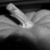 A grayscale animated icon shows a hand holding a small object with a bright glow, the hand's position shifts slightly across frames.