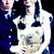 Pixelated static image of two figures in formal attire against a dark background with blue accents.