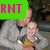 A pixelated image of a man holding a child, with three colored text overlays changing across frames.