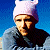 Pixelated buddy icon split into two sections: left side shows a person in a white beanie and gray jacket against blue sky, right side displays green text on dark green background reading "Original Icons .com".