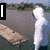 A person in a white hoodie walks along a wooden plank over water, with text overlays changing across frames.