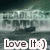 Pixelated image with dark green and gray background showing a blurred figure, overlaid with white text reading "Love It :)" in two separate boxes.