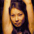 A 50x50 pixel animated contact sheet showing two frames of a woman with dark hair raising her arms against a green background with "OriginalIcons.com" text.