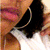 A pixelated close-up of a person's face showing lips, teeth, and part of the nose with warm-toned skin tones.