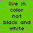 Green background with pink pixel dots and repeated dark blue text reading "live in color not black and white" arranged in a pattern