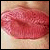 Pixelated close-up of lips with pink and red tones against a light beige background.
