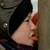 Static 50x50 pixel icon showing a close-up of a person's face with red lips and dark hair against a textured background.