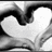 Two overlapping white hearts with black outlines on a grayscale background, rendered in low-resolution pixel art style.
