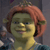 Pixelated image of a green-skinned character with reddish-brown hair wearing a yellow top against a dark background.